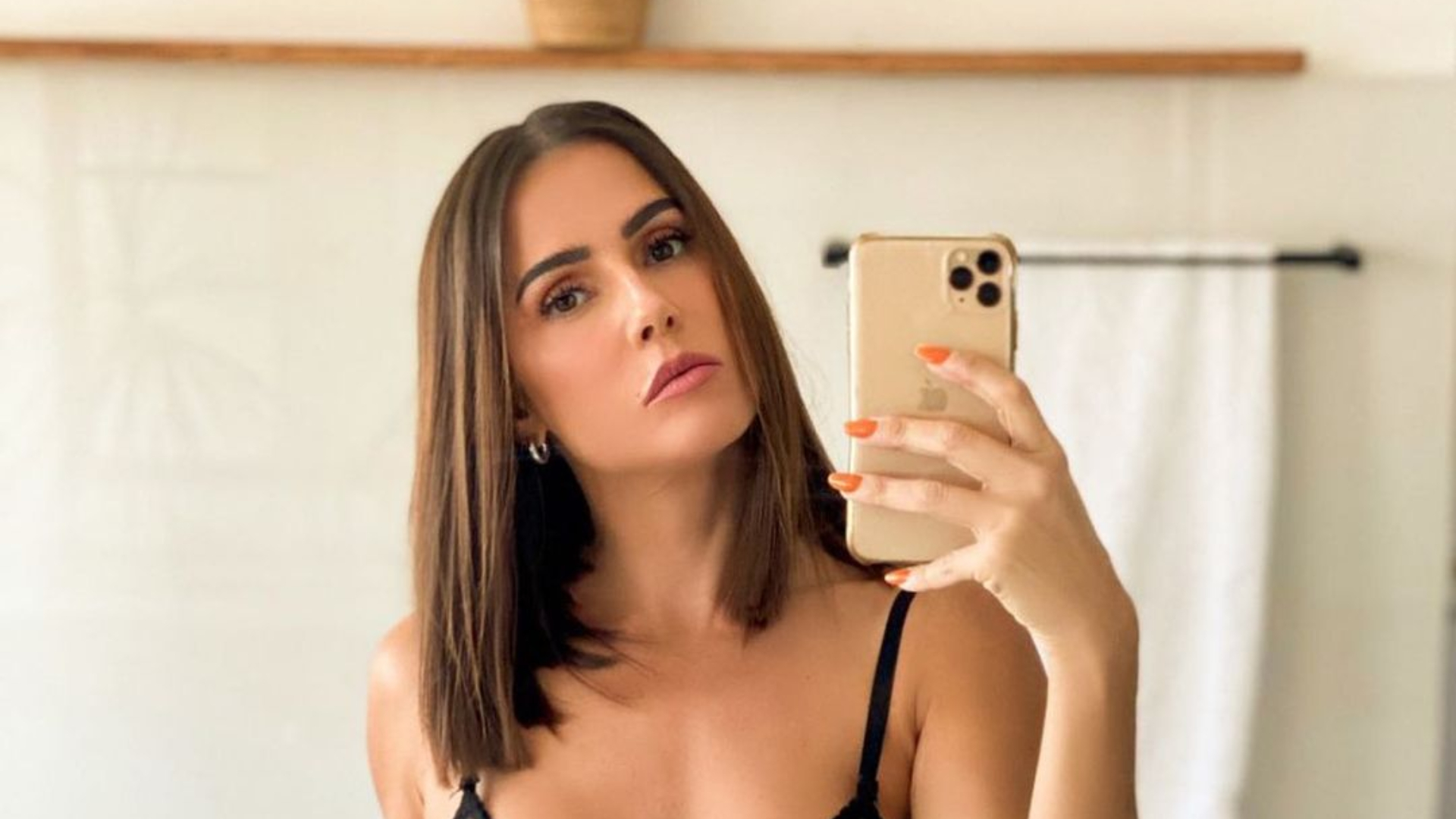 Deitada na cama, Deborah Secco sensualiza sem sutiã